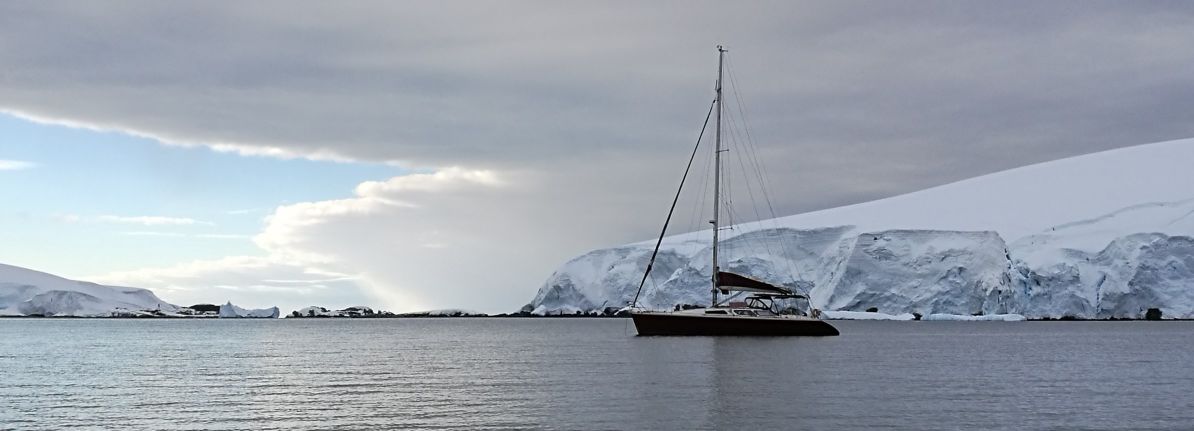 Antarctica  - Our boat anchored among the icebergs